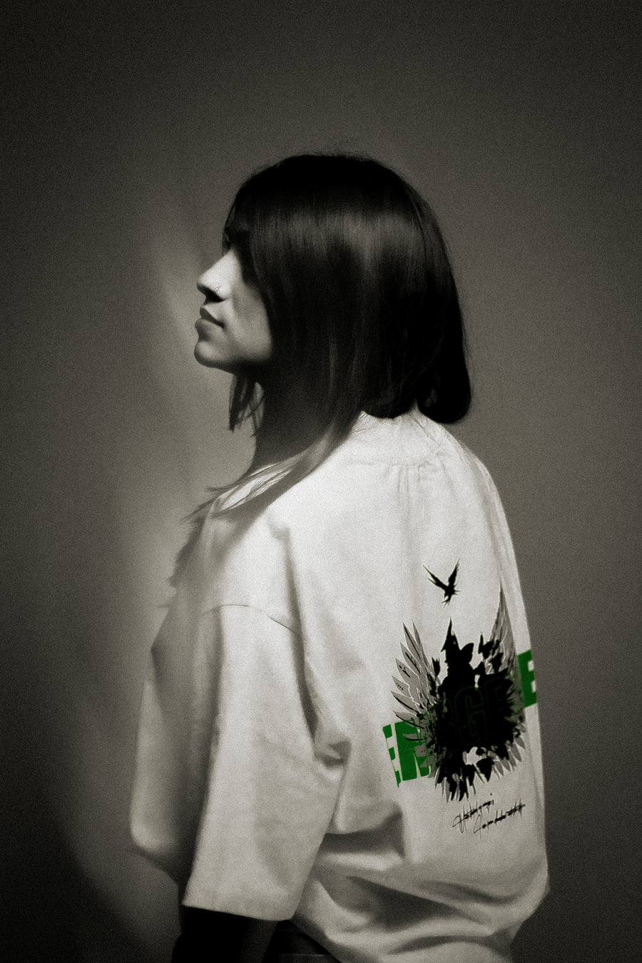 Model wearing optic white oversized graphic tee — dark luxury streetwear | YTHRAL© Emergence